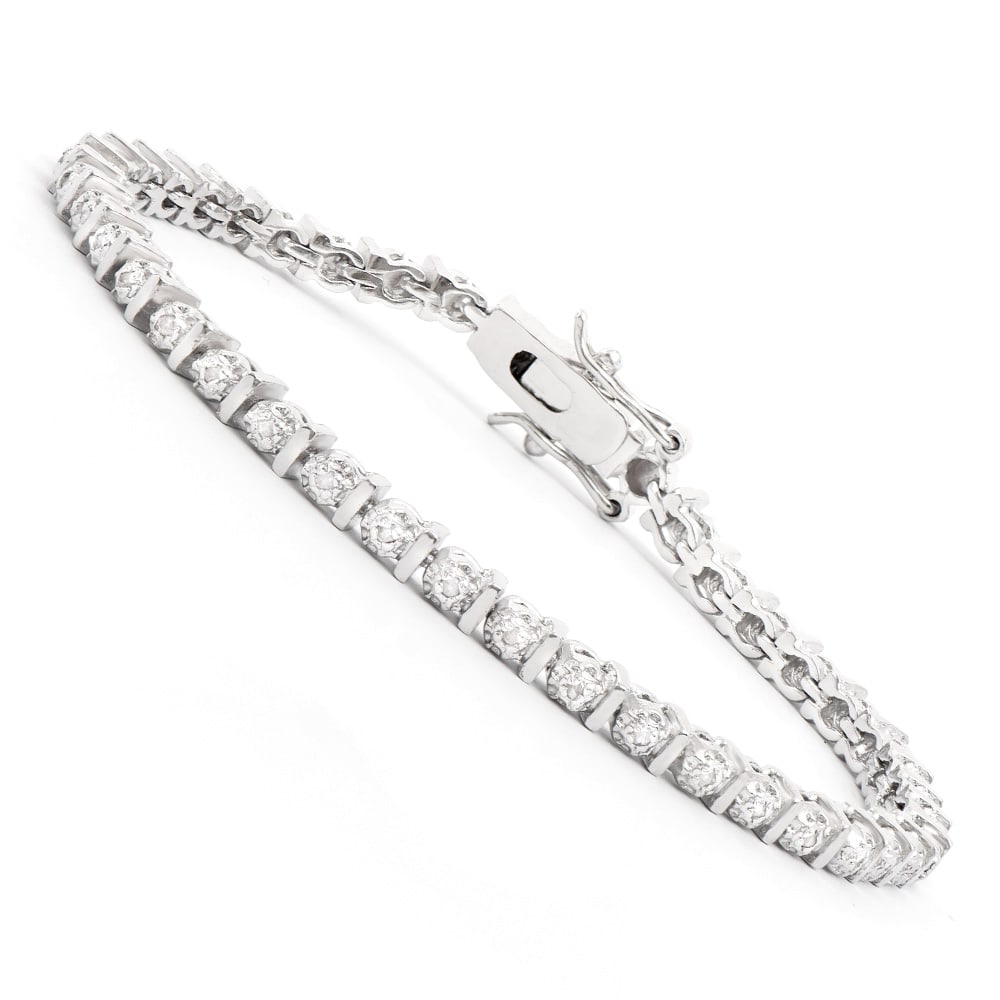 Plated Rhodium Diamond Bracelet: One Plated Rhodium Diamond Bracelet. Diamonds with a total weight of 0.15cts with a color of I-J and clarity of I-3. Total weight of this bracelet is 9.05 grams. The length of this bracelet is 7 1/2 i