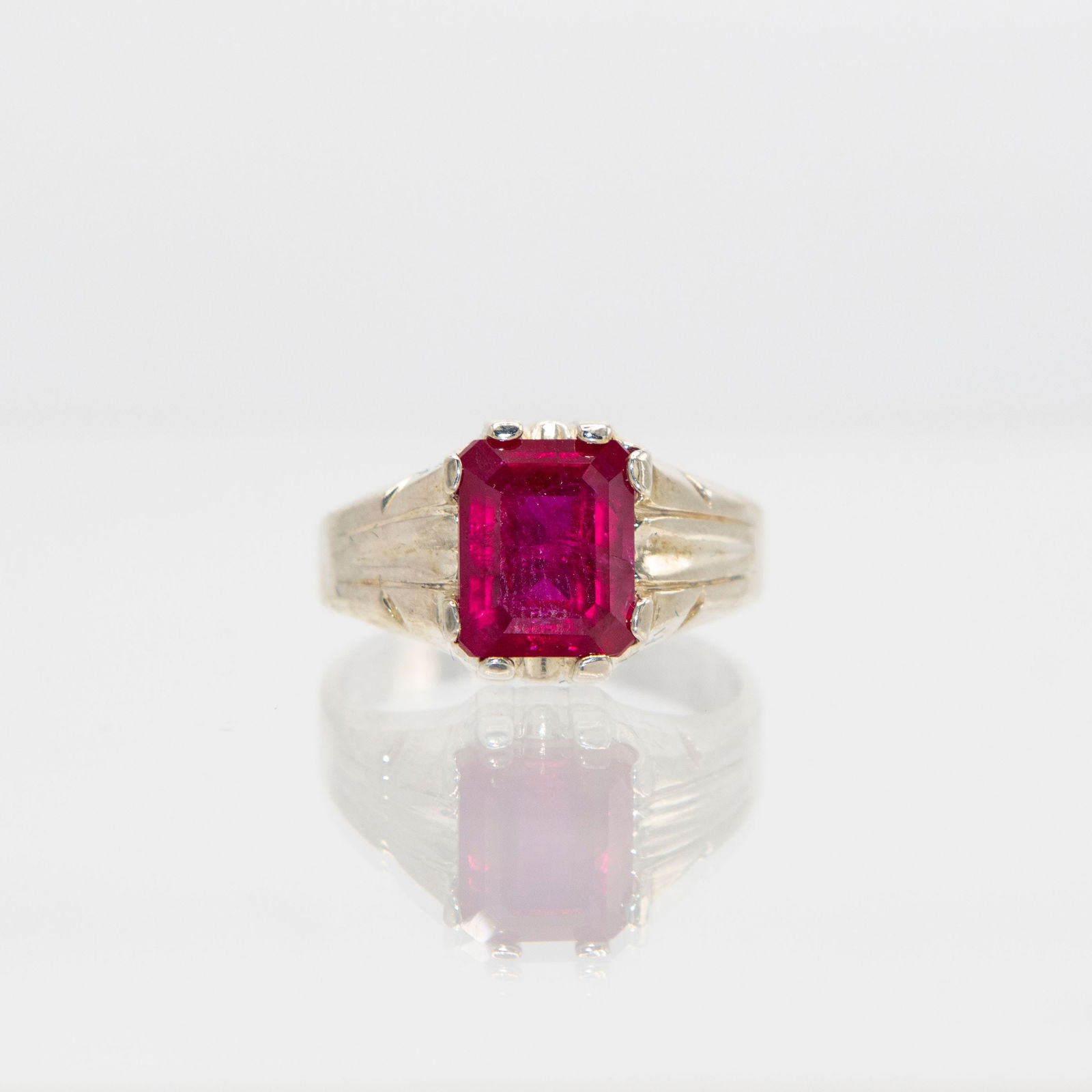 Beautiful 5 Ct VVS1 Fine Lab Ruby Ring: This lab created ruby ring is near flawless. Beautiful emerald cut mounted in elaborately designed solid .925 silver. Size 9. Total gram wt is 5.5 grams or 27.5 cttw. Please note : This ruby has the s