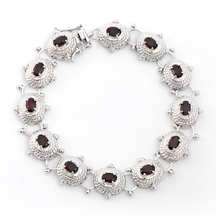 Plated Rhodium 6.05cts Garnet Bracelet: One Plated 6.05 TWcts Garnet Rhodium Bracelet 8.1 in. (12) Brown Garnet stones with a total weight of 6.05cts. Total weight of this bracelet is 21.82 grams.