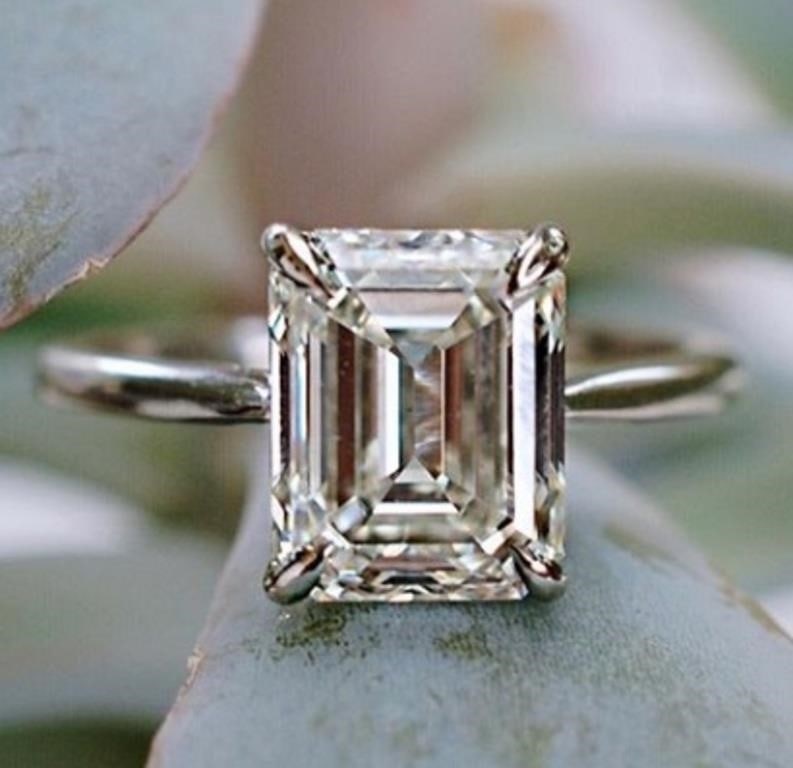 Plated 14KT White Gold Plate Emerald Cut 2.5ct VVs1 White Fire F-G Moissanite Ring: Dazzling Emerald Cut 2.5 Ct VVS1 White F-G Fire Moissanite Ring. This 2.5 Ct. Fire Moissanite is a VVS1 Brilliant Emerald Cut. The Color is White F-G measuring approx. 9.5 x 7.5mm. This Fire Moissanit