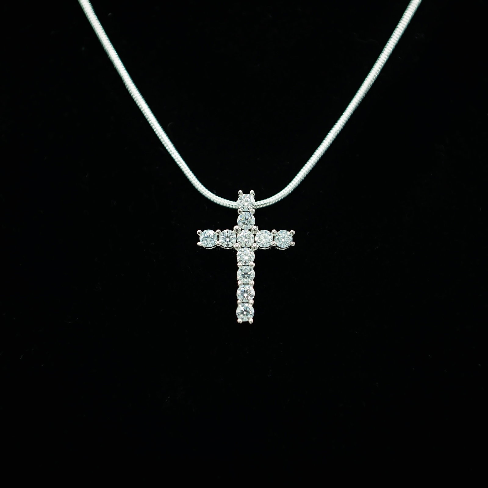 Plated 14KT White Gold Fire Moissanite Cross Pendant: These 11 Fire Moissanites Are VVs1 eye clean brilliant round cuts measuring 3.8 mm. The color is F-G. With a refractive index of 2.65-2.69, These Fire Moissanites exhibits more brilliance and fire tha