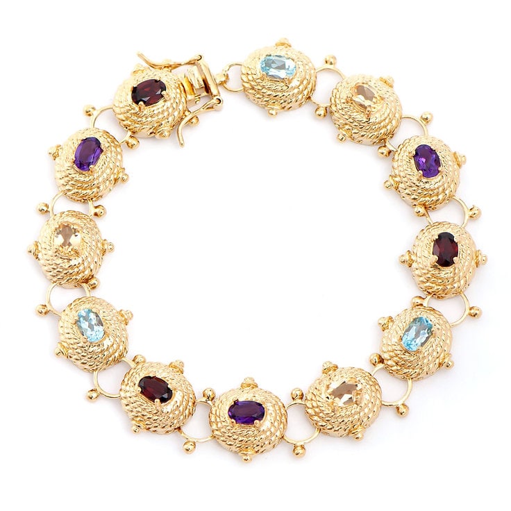 Plated 18KT Yellow Gold 5.75cts Multistone Bracelet: One Plated 18KT Yellow Gold 6.25cts Blue Topaz Bracelet 8.1 in. (3) Violet Amethyst stones with a total weight of 1.25cts. (3) Orange Citrine stones with a total weight of 1.25cts. (3) Brown Garnet st