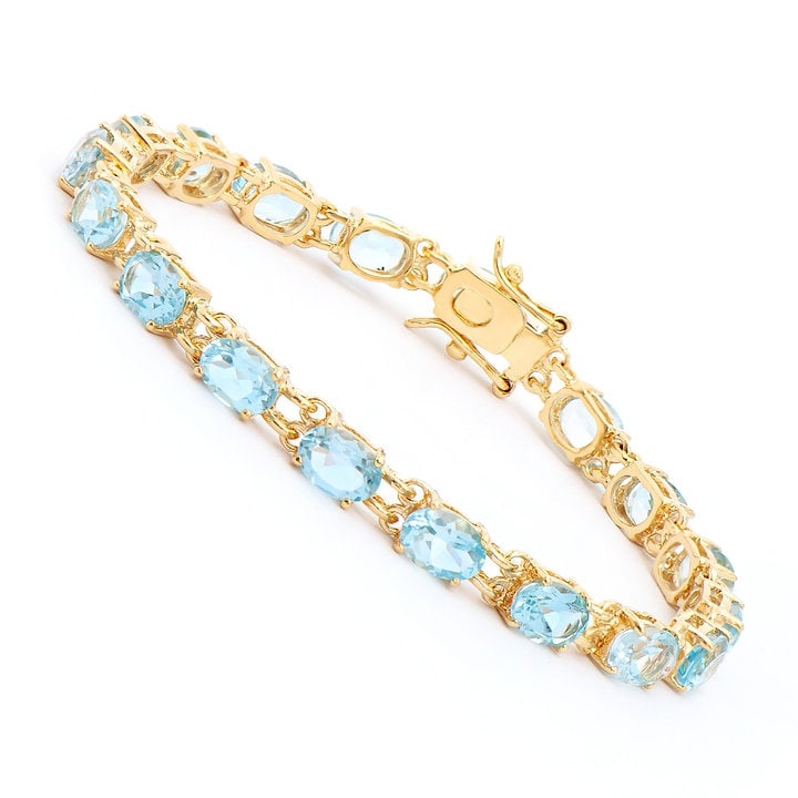 Plated 18KT Yellow Gold 17.20ctw Blue Topaz Bracelet: One Plated 18KT Yellow Gold 17.20ctw Blue Topaz Bracelet. (18) Blue Topaz stones with a total weight of 17.20cts. Total weight of this bracelet is 10.37 grams. The length of this bracelet is 7.25 inch