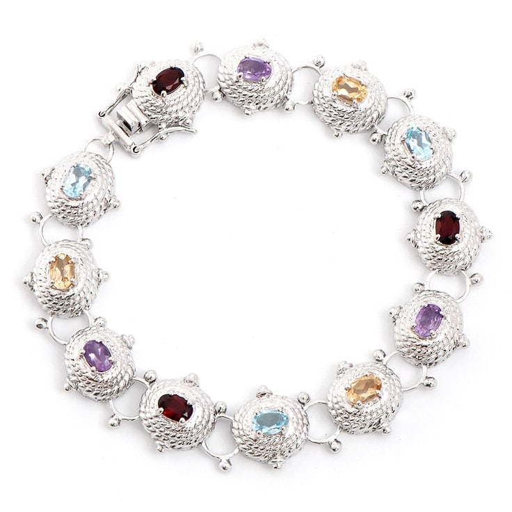 Plated Rhodium 5.75cts Multistone Bracelet: One Plated 5.75cts Multistone Rhodium Bracelet 8.1 in. (3) Violet Amethyst stones with a total weight of 1.25cts. (3) Orange Citrine stones with a total weight of 1.25cts. (3) Brown Garnet stones with