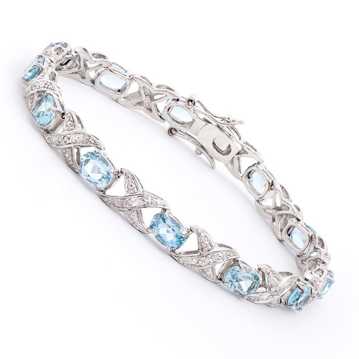 Plated Rhodium 11.26ctw Blue Topaz and Diamond Bracelet: One Plated Rhodium 11.30ctw Blue Topaz and Diamond Bracelet. (12) blue Topaz stones with a total weight of 11.26cts. (12) Diamonds with a total weight of 0.10cts with a color of H-I and clarity of I-3