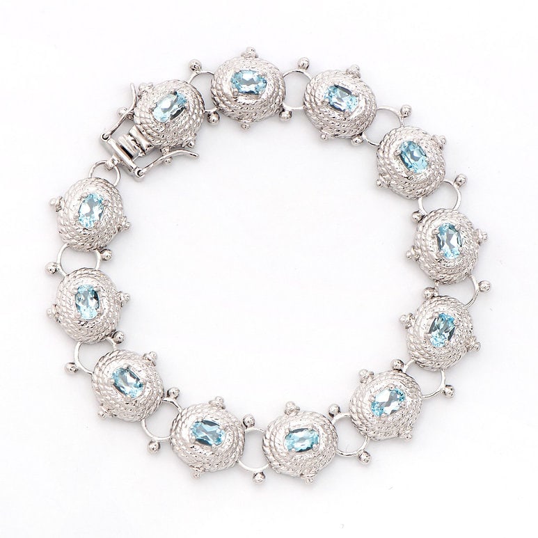 Plated Rhodium 6.55cts Blue Topaz Bracelet: One Plated 6.55cts Blue Topaz Rhodium Bracelet 8 in. (12) Blue Topaz stones with a total weight of 6.55cts. Total weight of this bracelet is 21.67 grams.