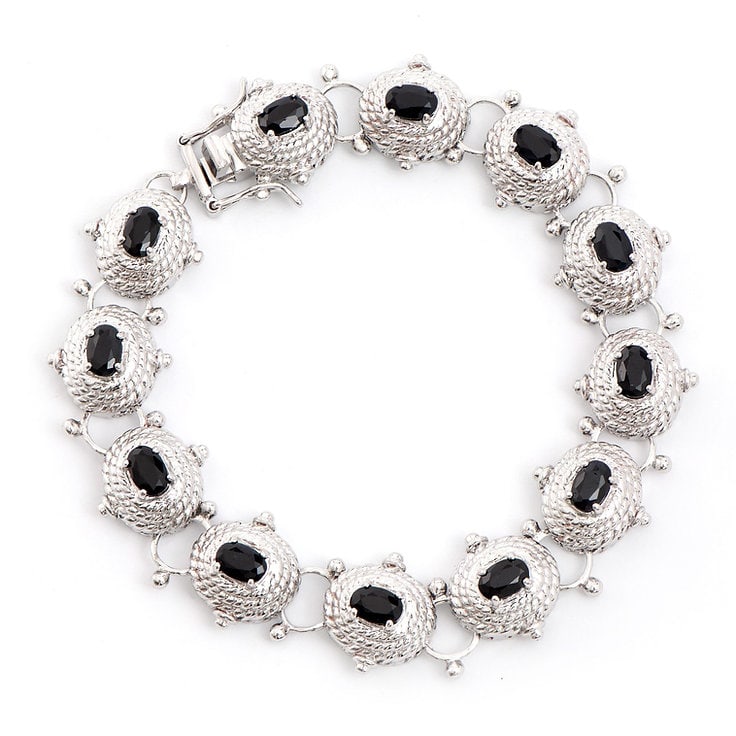 Plated Rhodium 7.45cts Sapphire Bracelet: One Plated 7.45cts Sapphire Rhodium Bracelet 8.1 in. (12) Black Sapphire stones with a total weight of 7.45cts. Total weight of this bracelet is 22.41 grams.