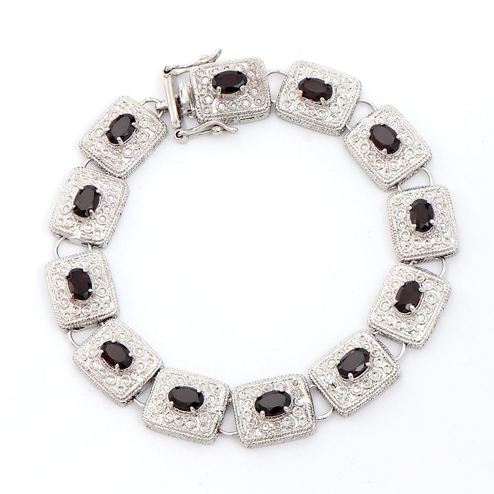 Plated Rhodium 5.05ctw Brown Garnet Bracelet: One Plated Rhodium 5.05ctw Brown Garnet Bracelet. (12) Brown Garnet stones with a total weight of 5.05cts. Total weight of this bracelet is 20.3 grams. The length of this bracelet is 7 1/2 inches.