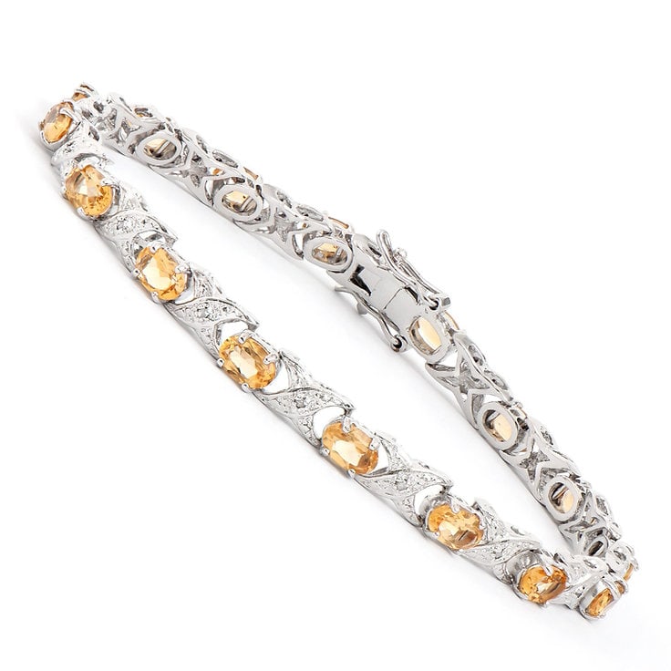 Plated Rhodium 6.54cts Citrine and Diamond Bracelet: One Plated 6.54cts Citrine and Diamond Rhodium Bracelet 8 in. (16) Orange Citrine stones with a total weight of 6.4cts. (16) diamonds with a total of 0.14cts with a color of H-I and clarity of I-3. To
