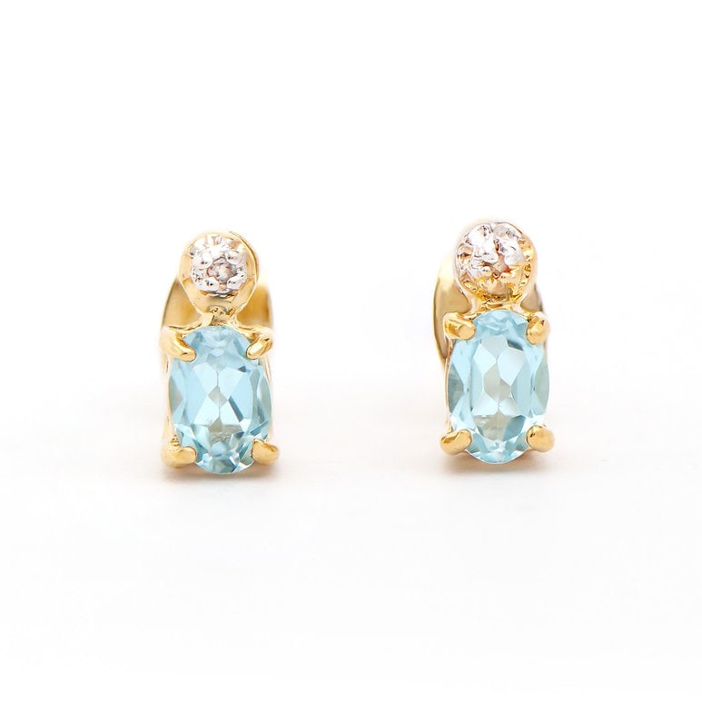 Plated 18KT Yellow Gold 1.12cts Blue Topaz and Diamond Earrings: One pair of Plated 18KT Yellow Gold 1.12cts Blue Topaz And Diamonds Earrings. (2) Blue Topaz stones with a total weight of 1.1cts. (2) diamonds with a total of 0.02cts with a color of H-I and clarity