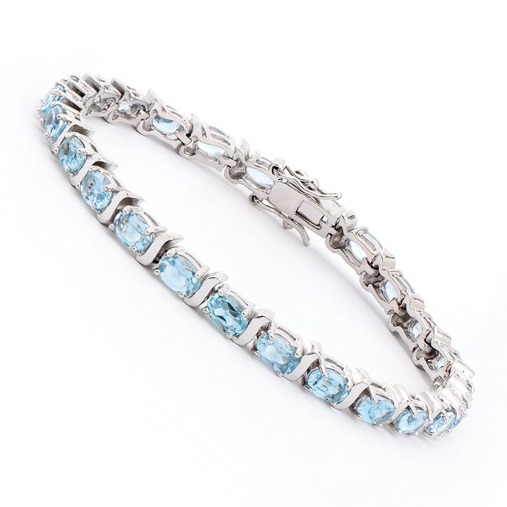 Plated Rhodium 13.50ctw Blue Topaz Bracelet: One Plated Rhodium 13.50ctw Blue Topaz Bracelet. (25) Blue Topaz stones with a total weight of 13.50cts. Total weight of this bracelet is 14.70 grams. The length of this bracelet is 7 1/2 inches.