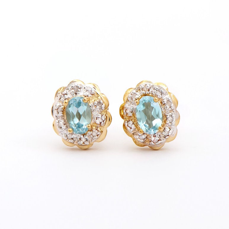 Plated 18KT Yellow Gold 1.3cts Blue Topaz and Diamond Earrings: One pair of Plated 18KT Yellow Gold 1.3cts Blue Topaz and Diamond Earrings. (2) Blue Topaz stones with a total weight of 1.12cts. (20) diamonds with a total of 0.18cts with a color of H-I and clarity