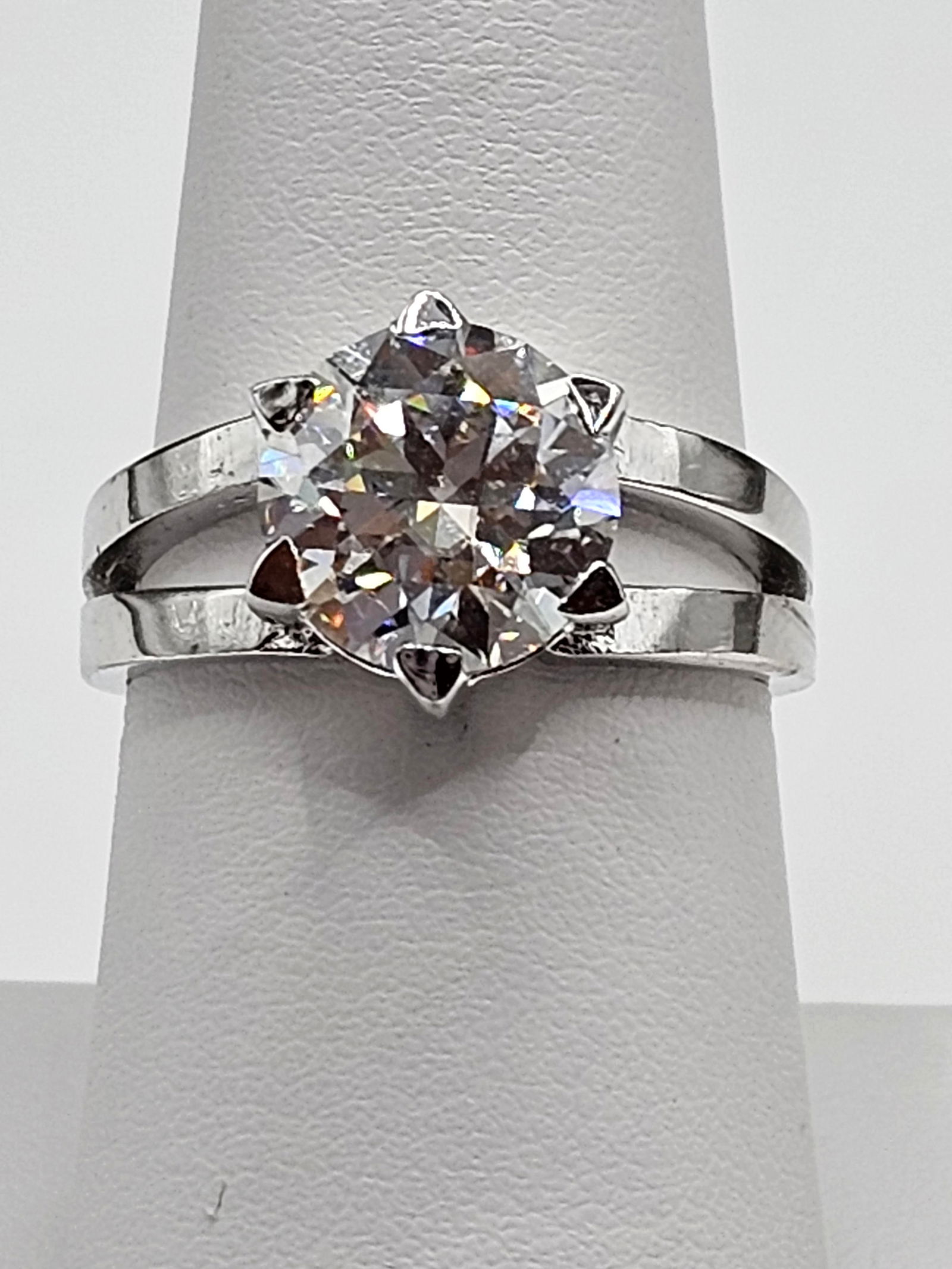 4.25ct VVs1 F-G Fire Moissanite Solitaire Ring: This 4.25 Fire Moissanite is a VVs1 Brilliant Round Cut. The Color is F-G with a clarity of VVs1.Eye Clean Measuring 10 mm. This Fire bursting out with a full spectrum of colors. It is mounted in .925