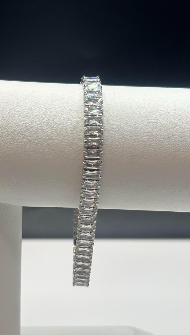 14 Kt White Gold Plated Lab Simulated Diamond Tennis Bracelet: Sparkling 14.5 Ctw Lab Simulated Diamond Tri-Layered 14 Kt White Gold Plated Tennis Bracelet. These 53 Lab Simulated Diamonds Are VVs1 Eye Clean Baguette Cuts Mounted In 14 Kt White Gold Overlay. Appr