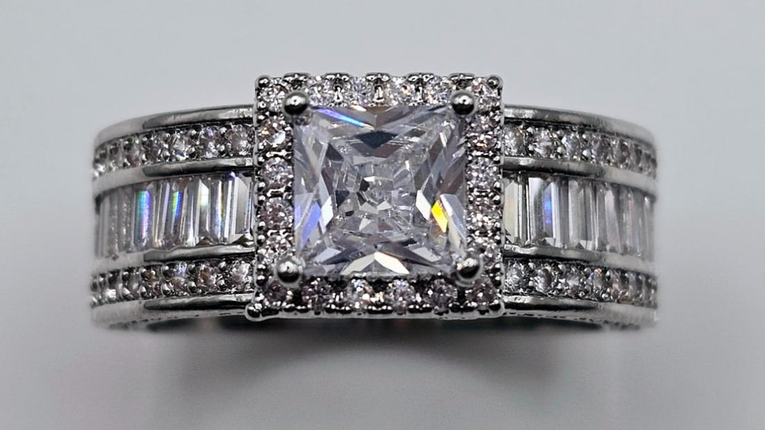 Stunning 1.5 Ct Princess Cut Simulated Diamond Ring: This 1.5 Ct VVs1 White F-G Lab Simulated Diamond Solitaire Is A Princess Cut Measuring 6.5 x 6.5 mm. It is eye clean and bursting out with a full spectrum of colors. This Spectacular High End Centerst