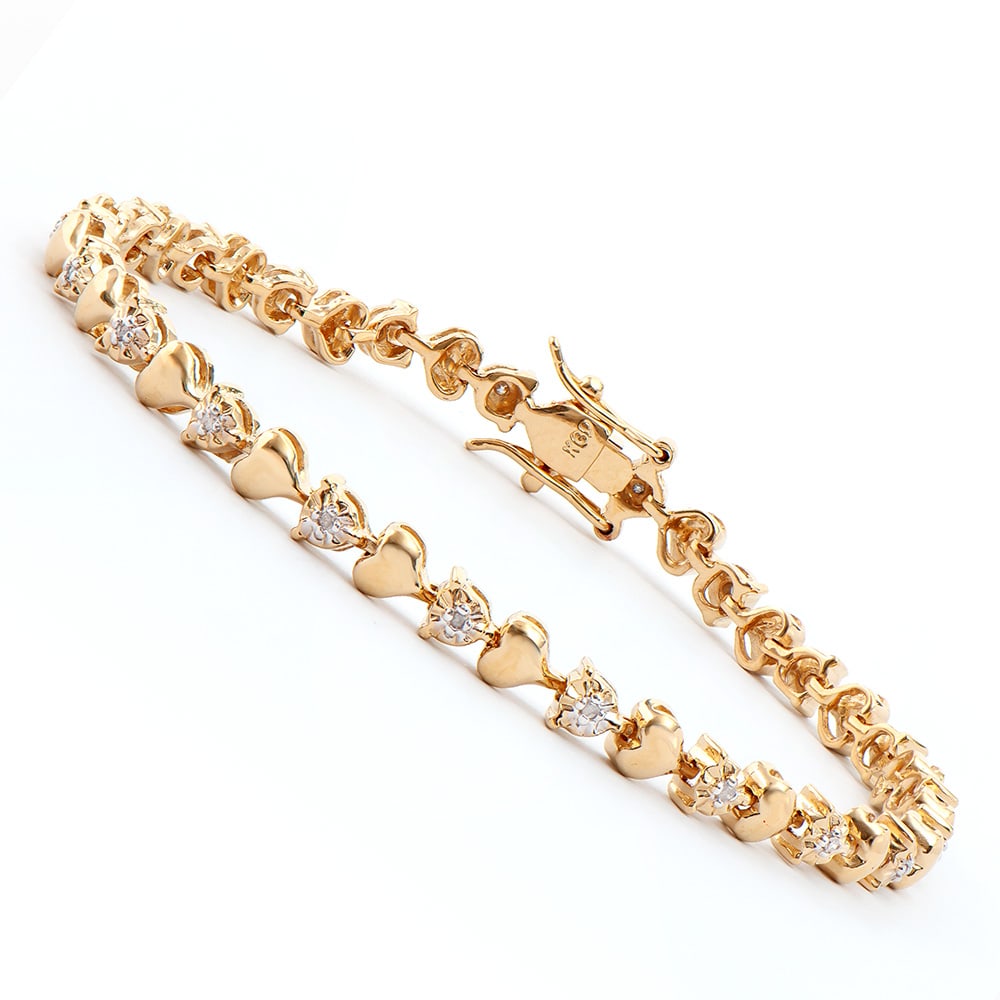 Plated 18KT Yellow Gold Diamond Heart Bracelet: One Plated 18KT Yellow Gold Diamond Heart Bracelet. 21 round Diamonds with a color of I-J and clarity of I-3. Total weight of this bracelet is 10.05 grams. The length of this bracelet is 7 1/2 inches.