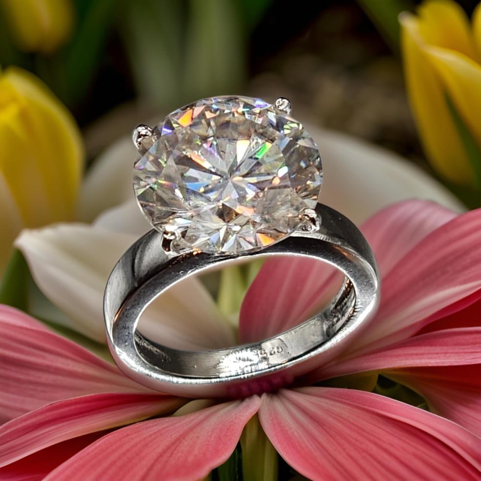 Huge Rare 14ct VVs1 White F-G Fire Moissanite Ring: This Stunning Moissanite Solitaire is a VVS1 Huge 14 Ct Brilliant Round Cut Measuring Approx. 15.7 mm. It is near flawless and bursting out with a full spectrum of colors. This Moissanite is Mounted i
