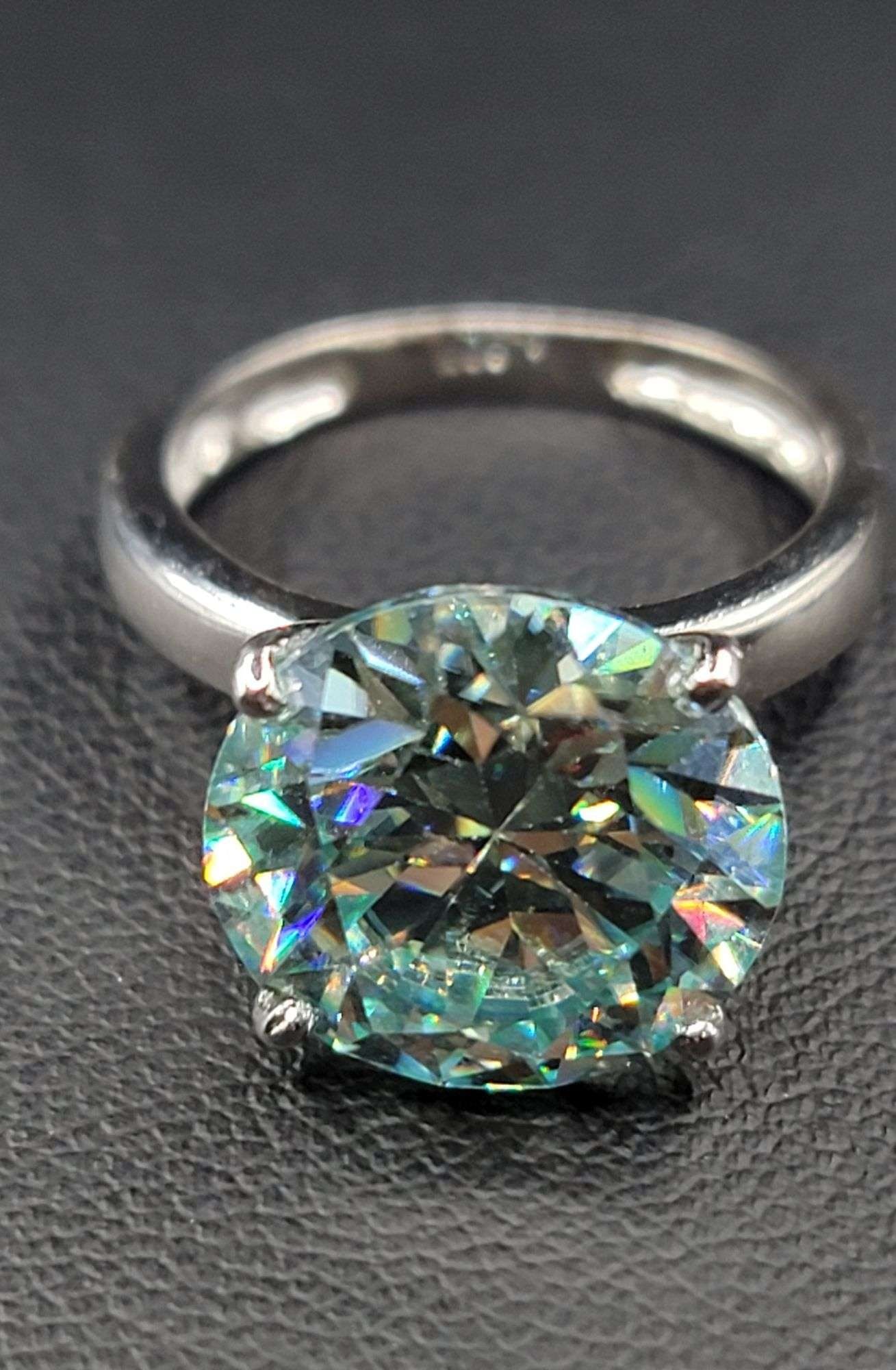 Plated 14KT White Gold 4.5ct Vvs1 Mint Green Fire Moissanite Ring: 14 Kt White Gold Plate 4.5 Ct Fire Moissanite Ring!!! This Ice Green Fire Moissanite is a VVs1 Brilliant Round Cut. The Color is Paraiba Greenish Blue with a clarity of VVs1.Eye Clean Measuring 10 mm.