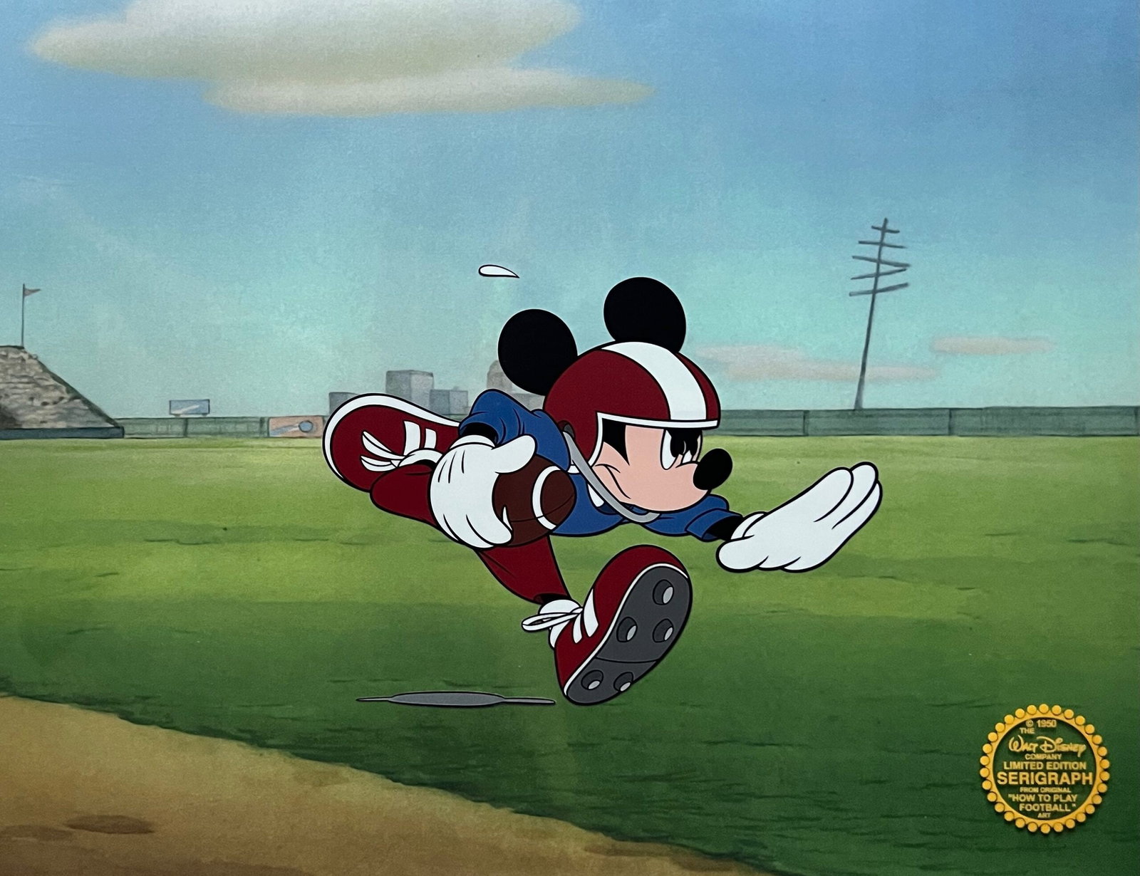 DISNEY MICKEY MOUSE FOOTBALL Sericel Animation Art Cel: This is a Limited Edition Serigraph Cel of Mickey Mouse playing football. Disney’s own artists have selected this scene from the ORIGINAL animation drawings used to produce this classic Disney film.