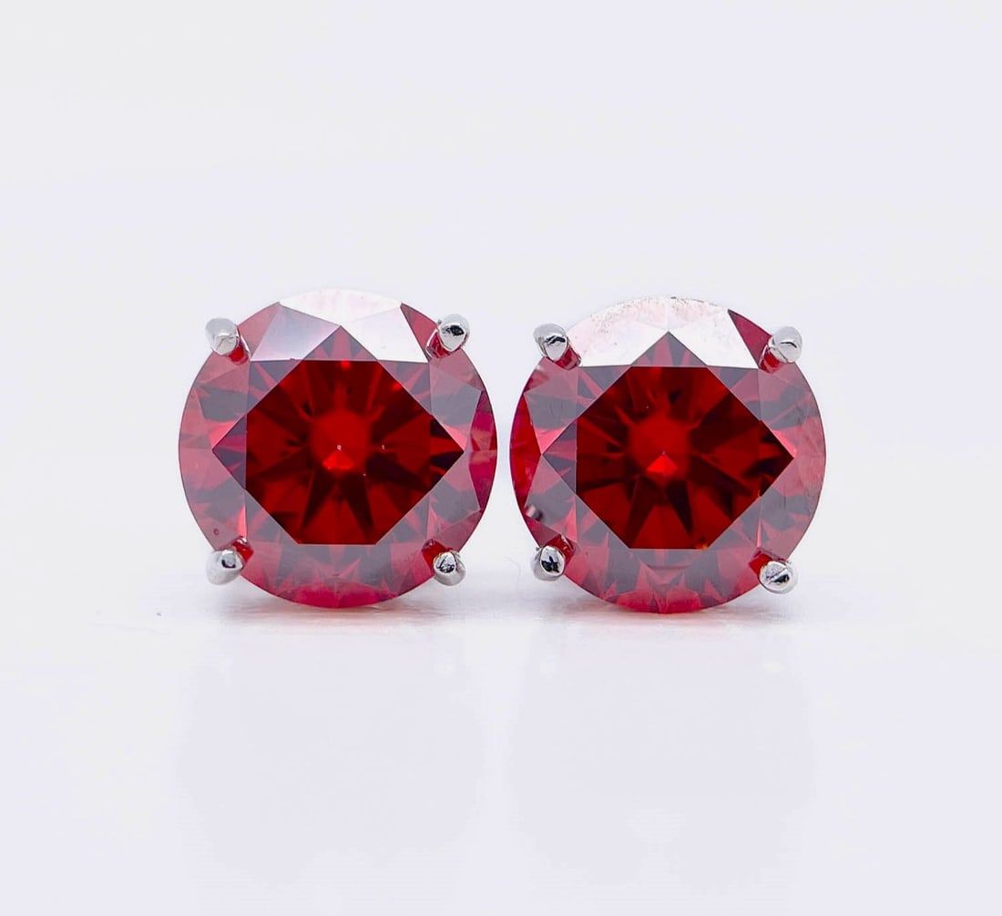 Plated 14KT White Gold 4.00ctw Hot Cherry Red Fire Moissanite Earrings: These Beautiful Large 4 Cttw Hot Cherry Red Moissanite Earrings are eye-clean and bursting out with a electric flashes of colors. They are Brilliant Round Cuts Measuring Approx 8 mm each and mounted i