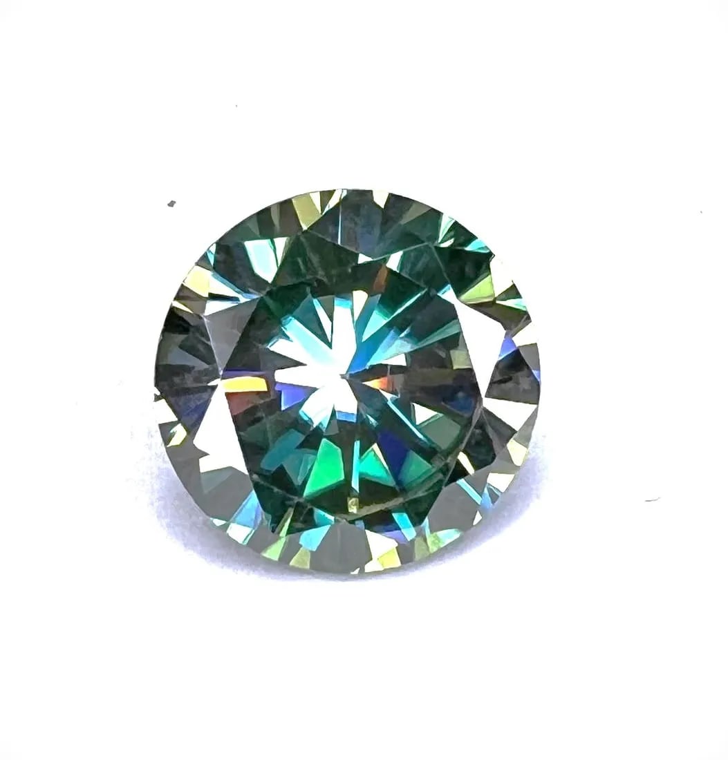 10.63ct VVs1 Deep Emerald Green Moissanite Solitaire: Fine Brilliant Round Cut Measuring approx. 10.63 mm. This Investment Grade Moissanite measures 9.25 on the mohs hardness scale. With a refractive index of 2.65-2.69, this moissanite exhibits more Fire