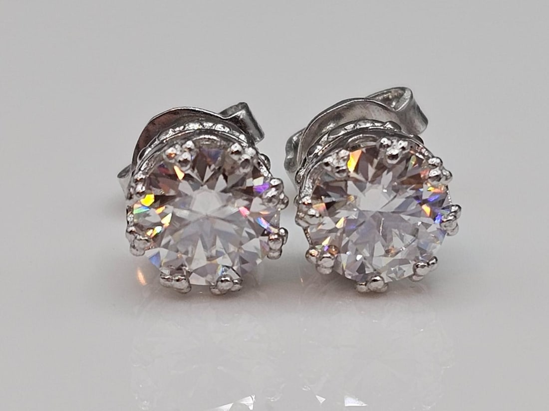 Sparkling 5.25 Ctw VVs1 F-G Lab Simulated Diamond Earrings: These Large 5.25 Cttw Fire Moissanites are Vvs1 Eye Clean and E-F in Color. They are both 7.1 mm. Brilliant Round Cuts. They are set in 14 Kt Tri-Layered White Gold over Solid .925 Sterling Silver Int
