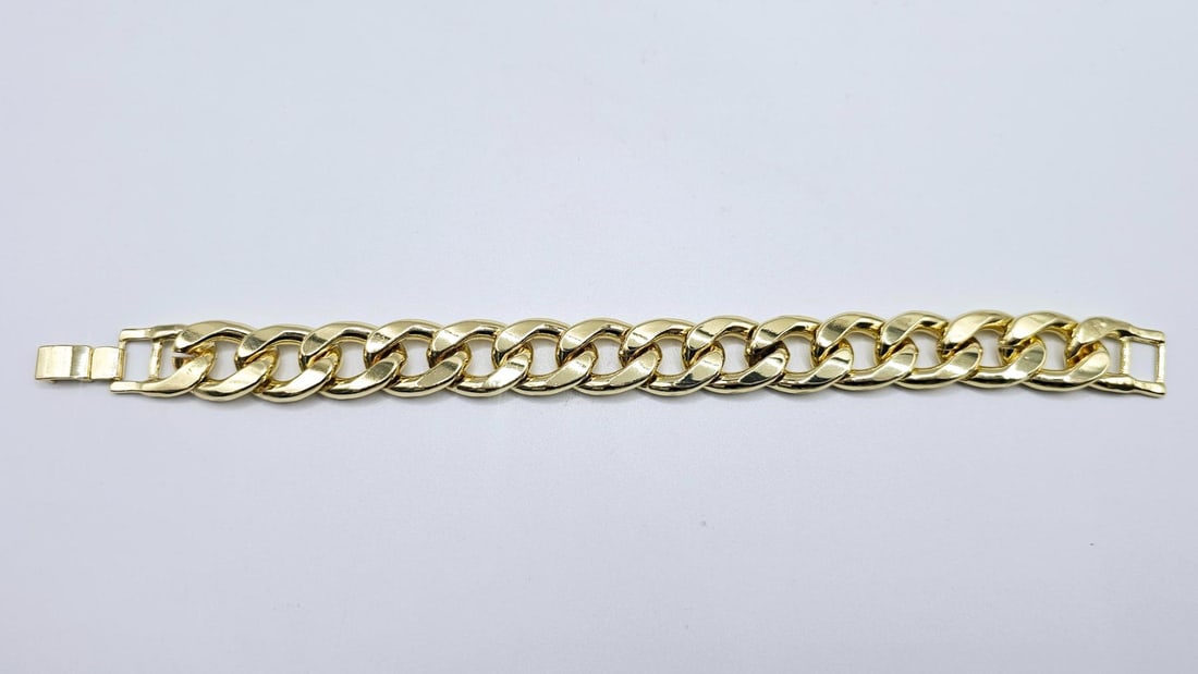 Strong 63.7 Gram 14 Kt Gold Plate Curb Link Bracelet: Strong and durable heavy 14k yellow gold plate curb link bracelet weighing 63.7 grams.8" in length.15 mm. wide. Sturdy dual safety clasp. This High Quality Bracelet Looks Like Solid Gold Without The S
