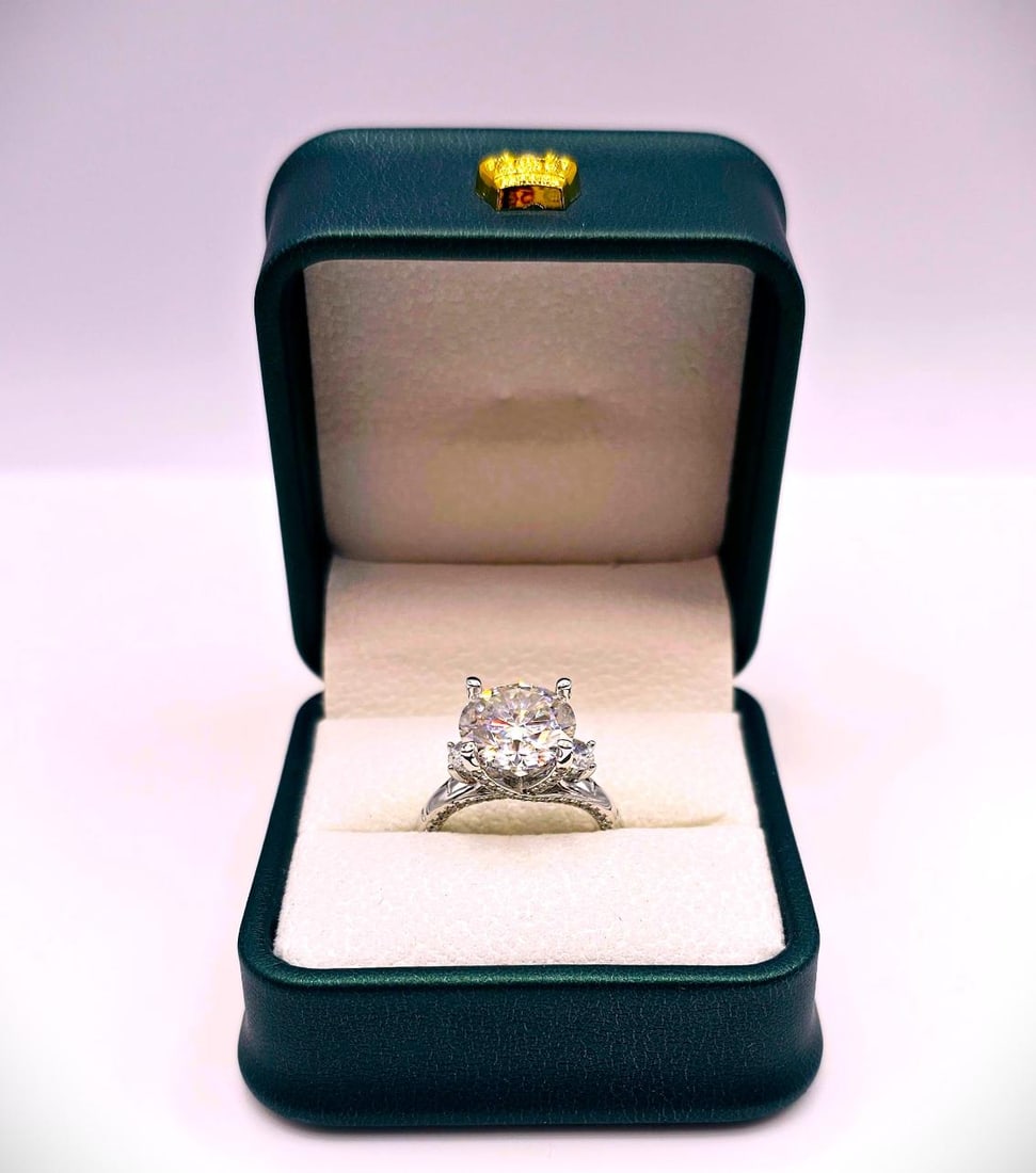 Sparkling 5.75 Ct 14 Kt White Gold Plated Engagement Ring: Sparkling Huge 5 Ct VVs1 Lab Simulated Diamond 14 Kt White Gold Plated Engagement Ring. This fine Centerstone is a VVs1 Brilliant Round Cut Measuring 11 mm. The Color is White E-F. It is eye clean and