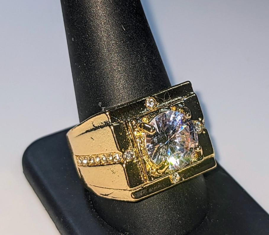 Men's 14 K Gold Plate 3.5 Ct VVs1 Simulated Diamond Ring: Men's Bold 14 Kt Yellow Gold Plated 3.5 Ct VVs1 Lab Simulated Diamond Ring. The center-stone is a 8.5 mm. Brilliant Round Cut, It is bursting out with a full spectrum of colors. This Ring is complimen