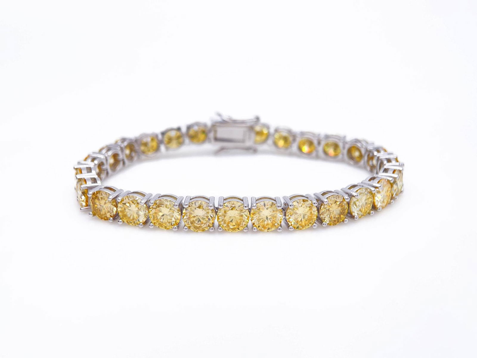 Plated 18KT White Gold 27 Ctw Ice Lemon Yellow Moissanite Tennis Bracelet: Gorgeous Bright 27 Ctw Ice Lemon Fire Moissanite Tennis Bracelet. These 27 Individual High Quality Moissanites are VVs1 Near Flawless Brilliant Round Cuts measuring 6.5mm. They burst out with a full s