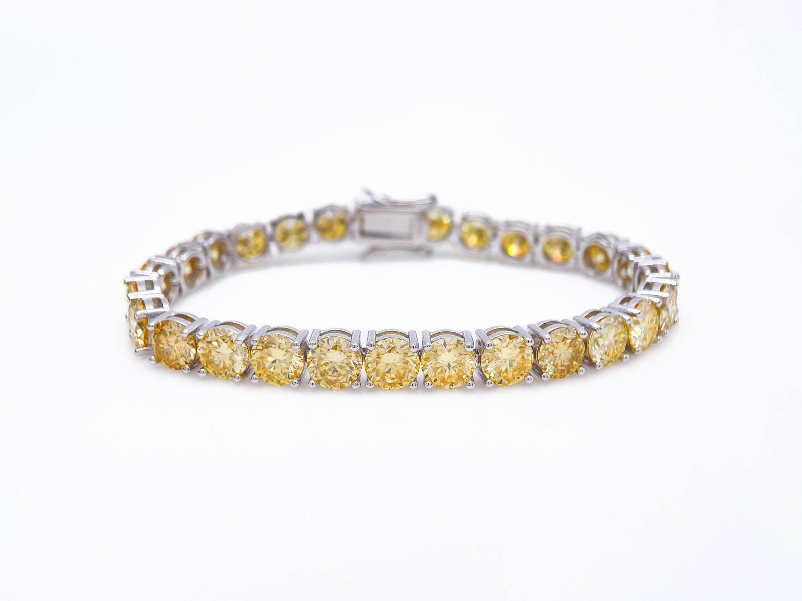 Plated 18KT White Gold 27 Ctw Ice Lemon Yellow Moissanite Tennis Bracelet: Gorgeous Bright 27 Ctw Ice Lemon Fire Moissanite Tennis Bracelet. These 27 Individual High Quality Moissanites are VVs1 Near Flawless Brilliant Round Cuts measuring 6.5mm. They burst out with a full s