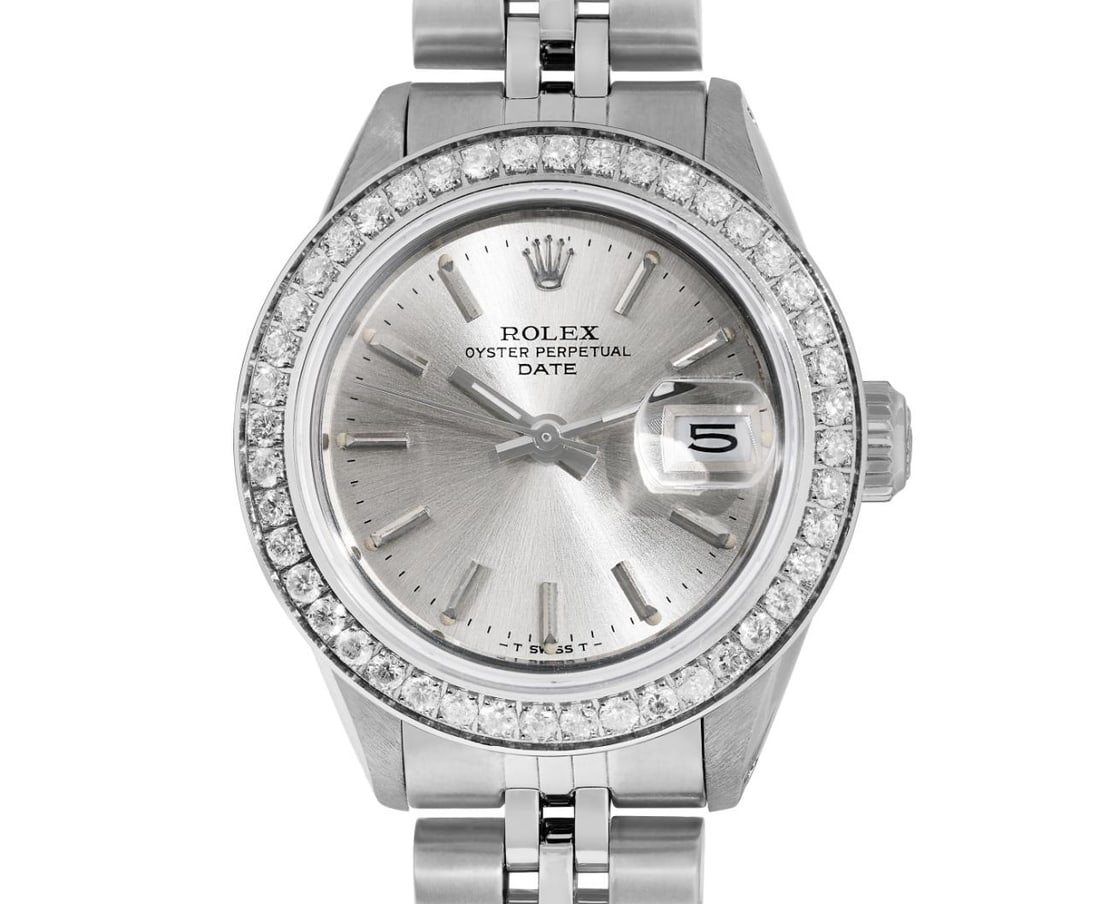 Rolex Ladies Stainless Steel Diamond Bezel Date Watch: This Lady Rolex Date watch features a silver dial with index hour markers and a custom sapphire crystal, with a magnified date window. The timepiece has a custom stainless diamond bezel, set with genu