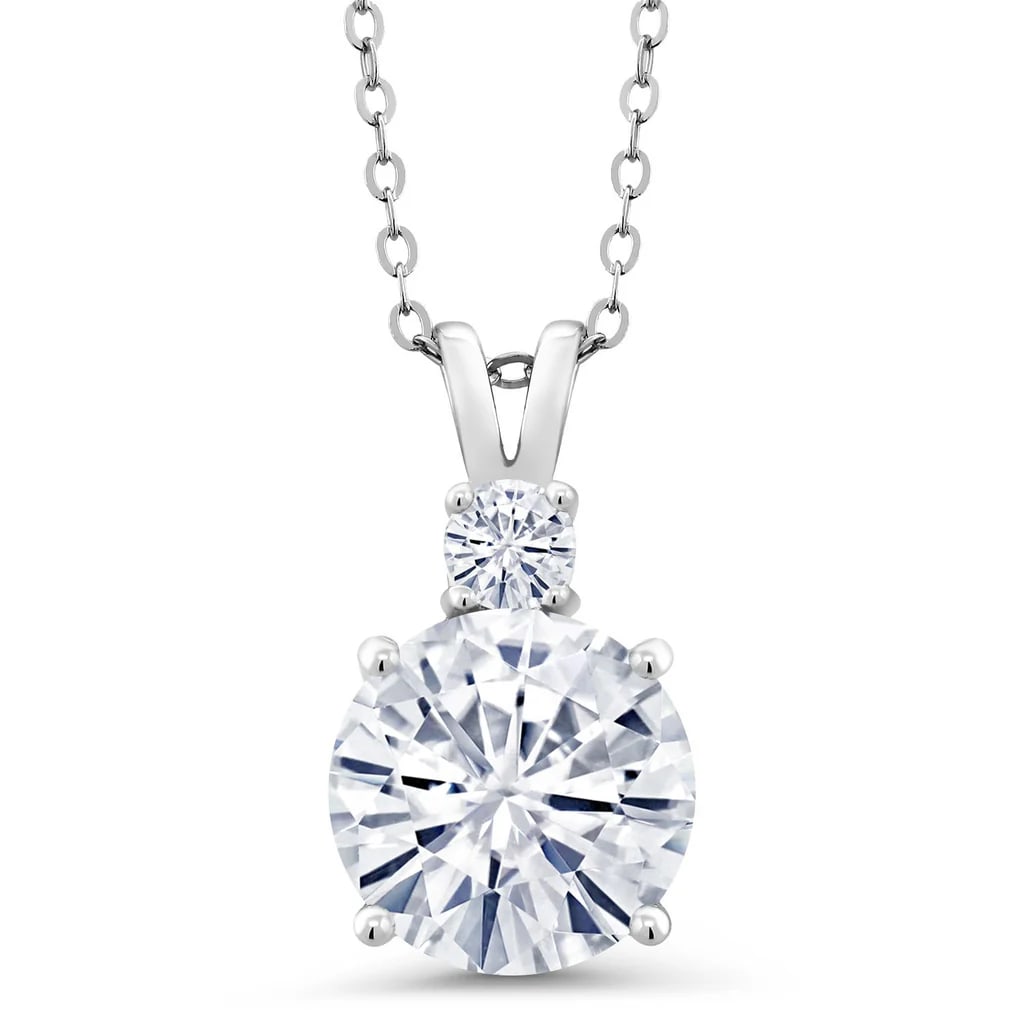 Sterling Silver 4.16ctw Moissanite Pendant with Chain: 4.16 CTTW Moissanite Pendant 4.00 ct Center. 0.16 ct Accent GH Color. Eye Clean Solid .925 Sterling Silver 18 inch Cable Chain. 10 mm Round Center Stone.