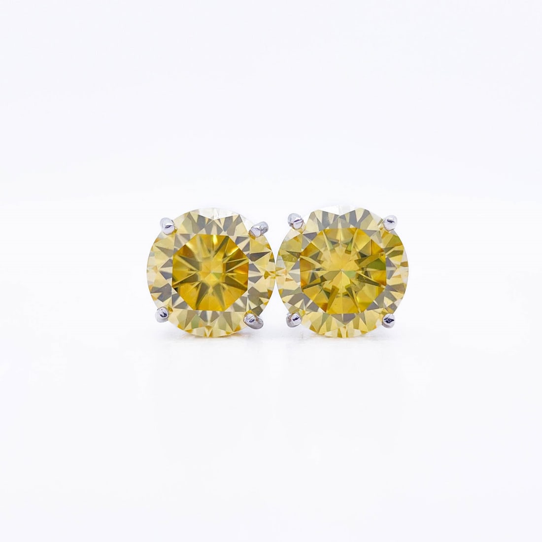 Plated 14KT White Gold 4.00ctw Ice Blue Fire Moissanite Earrings: These Beautiful Large 4 Cttw Lemon Yellow Fire Moissanite Earrings are eye-clean and bursting out with a full spectrum of Colors. They are Brilliant Round Cuts Measuring Approx 8 mm each and mounted i