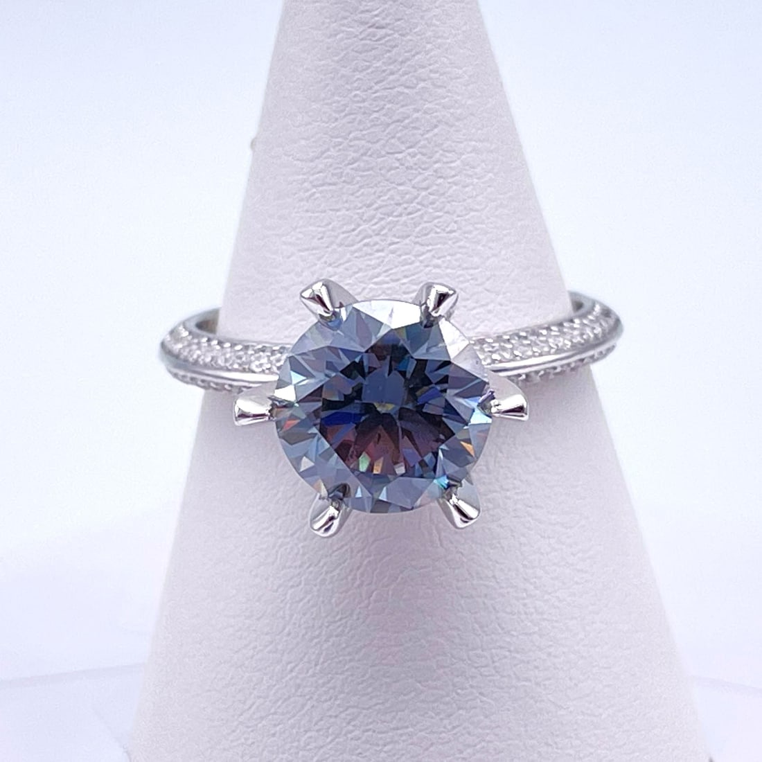 Plated 14KT Gold 3 Ct Smokey Blue/Grey Fire Moissanite Ring: This Fine 3 Ct Moissanite Centerstone is a VVS1 Brilliant Round Cut Measure sing 9 mm. The Color is a Lovely Smokey Blue/Grey. This Fire Moissanite is near flawless and bursting out with a full spectr