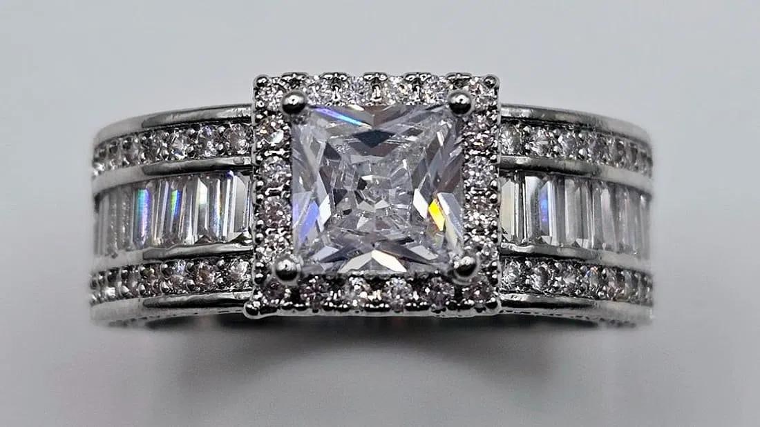 Stunning 1.5 Ct Princess Cut Simulated Diamond Ring: This 1.5 Ct VVs1 White F-G Lab Simulated Diamond Solitaire Is A Princess Cut Measuring 6.5 x 6.5 mm. It is eye clean and bursting out with a full spectrum of colors. This Spectacular High End