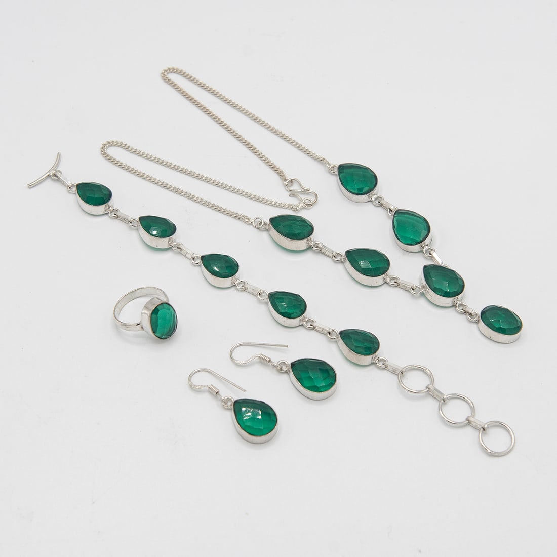 Lab Created Stunning 4 Piece Tsavorite Garnet Jewelry Set: Stunning 4 Piece Tsavorite Garnet Jewelry Set. These lab made tsavorites are near flawless. They burst out with a dazzling sparkle and vivid even tone. The 4 piece set includes an 18 inch 6 single sto