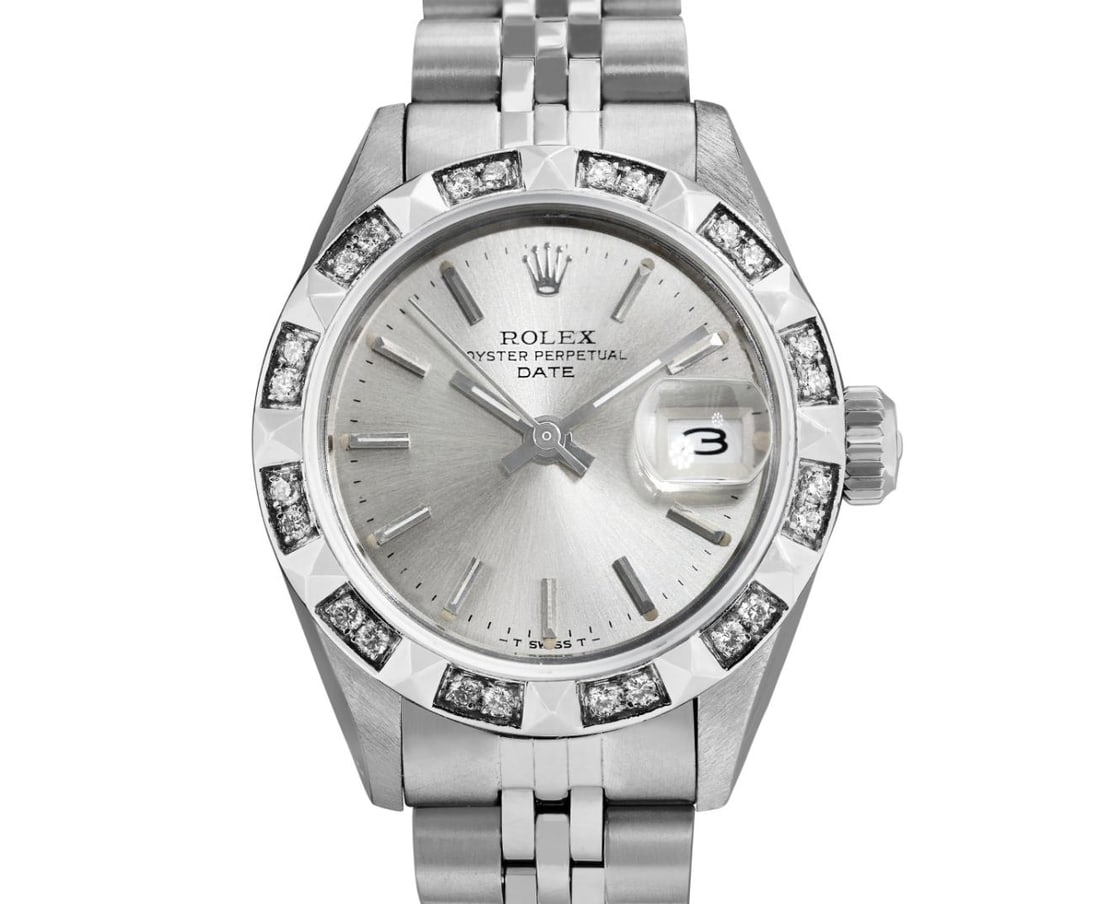 Rolex Ladies Stainless Steel Pyramid Diamond Bezel Date Watch: This Lady Rolex Date watch features a silver dial with index hour markers and a custom sapphire crystal, with a magnified date window. The timepiece has custom 18K white gold pyramid diamond bezel,