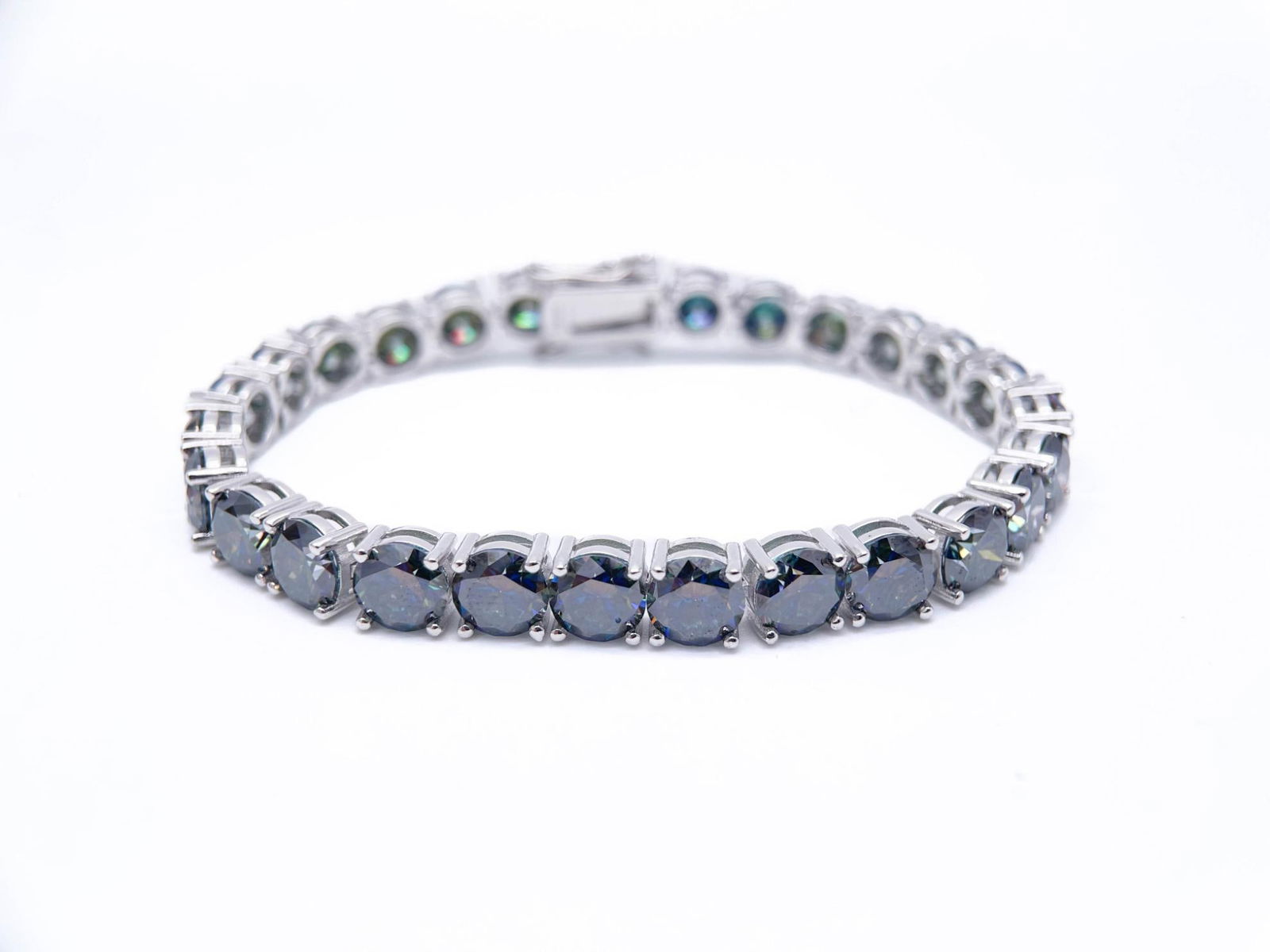 Plated 18KT White Gold 27 Ctw Deep Purple Fire Moissanite Tennis Bracelet: 18 Kt White Gold Plate 27 Ctw Deep Purple Amber Fire Moissanite Tennis Bracelet. These 27 Individual moissanites are Near Flawless VVs1 Brilliant Round Cuts Measuring 6.5 mm. They are a Deep Cherry