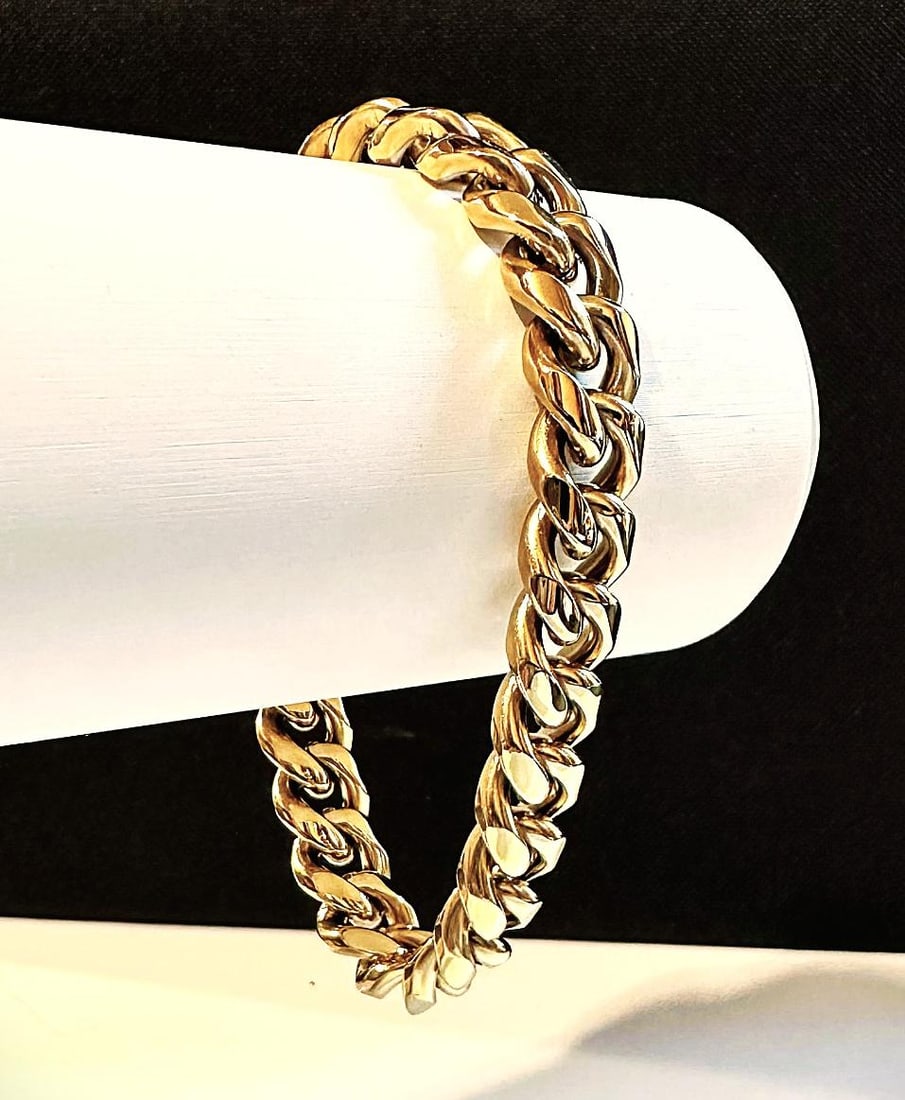 Huge 63.9 Gram Yellow 14 Kt Gold Plate Cuban Curb Link Bracelet: This Top Notch 63.9 Gram 14 Kt Gold Plated Bracelet Measures A Stealth 12 mm. Wide and is 9" Long, It is secured by a Double Safety Clasp. A-1 Quality . Top Notch. Looks Like Solid Gold Without The So