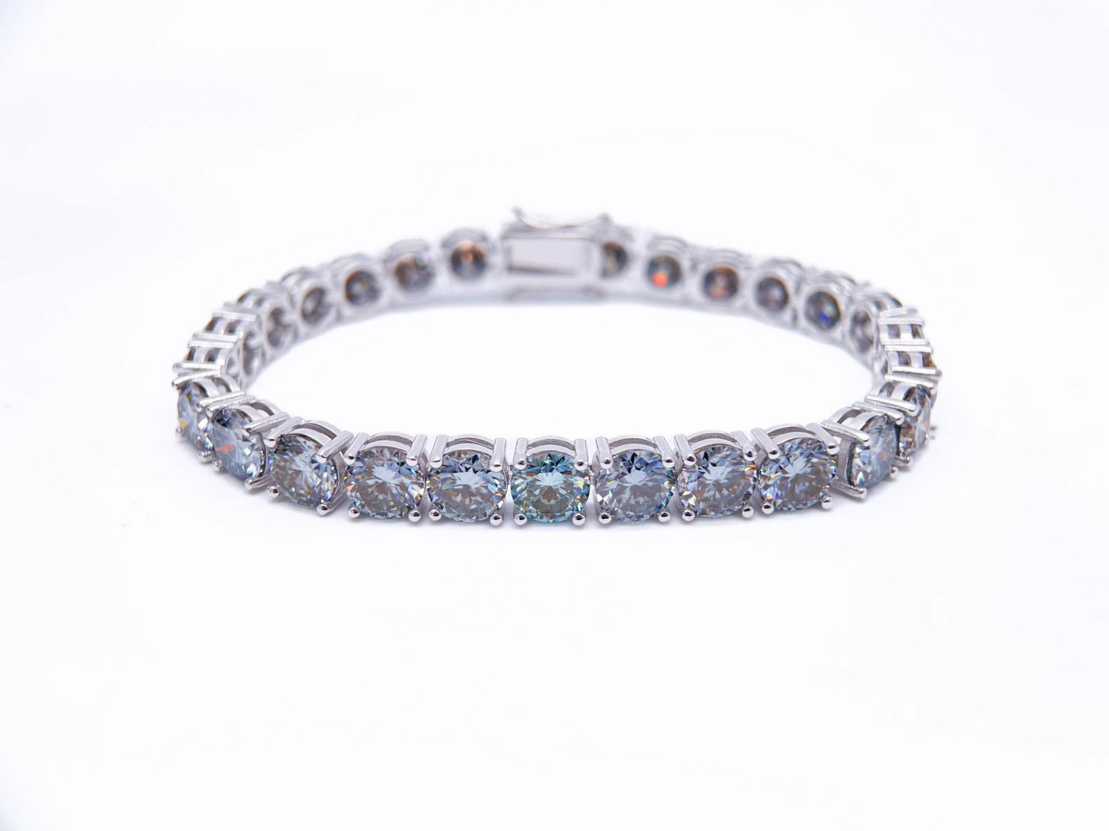 Plated 18KT White Gold 27.00ctw Steel Blue Gray Fire Moissanite Tennis Bracelet: 18 Kt White Gold Plate 27 Ctw Steel Blue Gray Fire Moissanite Tennis Bracelet. These 27 Individual Blue Gray moissanites are VVs1 Brilliant Round Cuts measuring 6.5mm. They burst out with a full