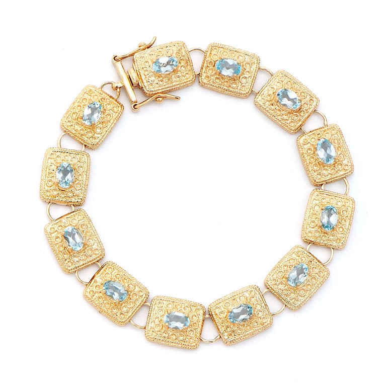 Plated 18KT Yellow Gold 6.55cts Blue Topaz Bracelet: One Plated 18KT Yellow Gold 6.55cts Blue Topaz Bracelet 7.75 in. (12) Blue Topaz stones with a total weight of 6.55cts. Total weight of this bracelet is 21.63 grams.
