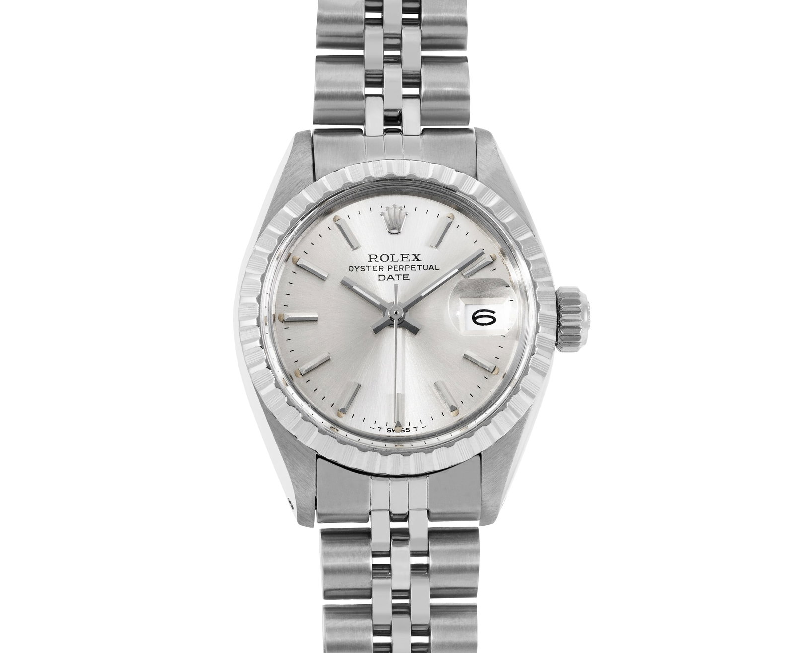 Rolex Ladies Stainless Steel 26MM Engine Turn Date Watch: This Lady Rolex Date watch features a silver dial with index hour markers and a custom plastic crystal, with a magnified date window. The timepiece has Rolex stainless steel engine turn bezel. The Rol