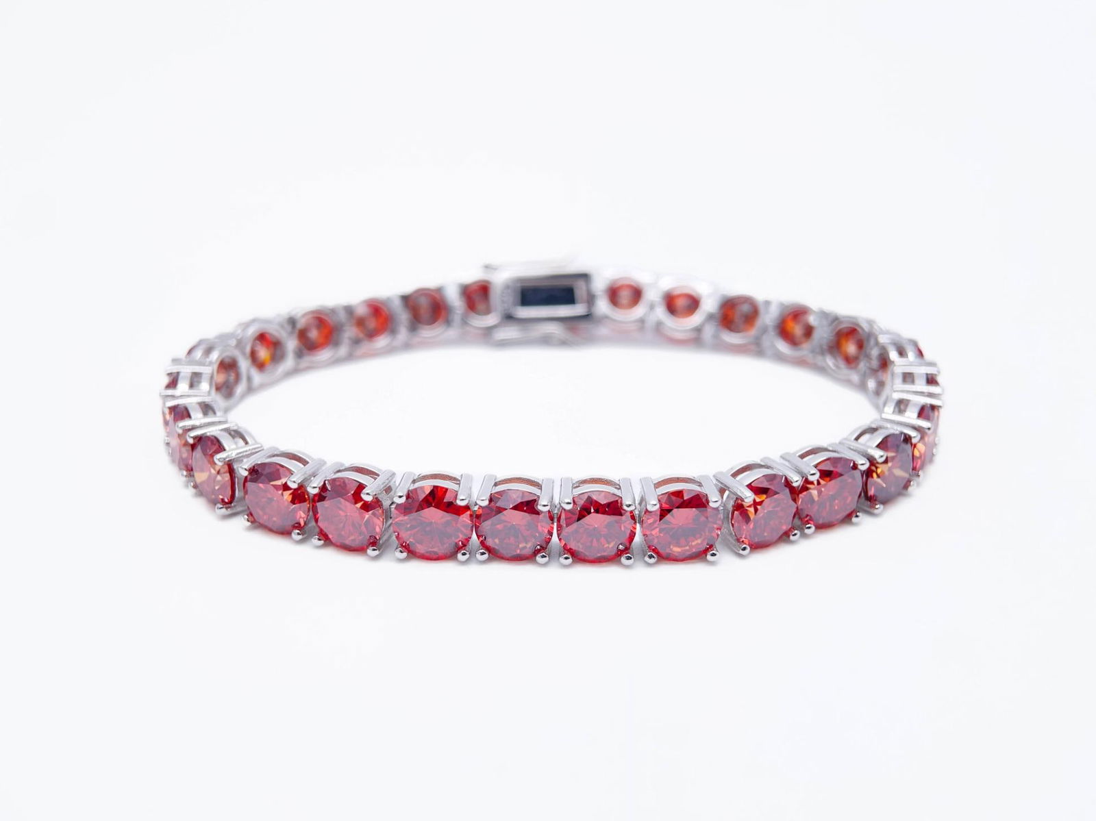 Plated 18KT White Gold 27.00ctw Simulated Padpaparacha Sapphire Bracelet: 18 Kt White Gold Plate 27 Cttw Simulated Orange Red Padpaparacha Sapphire Tennis Bracelet. These 27 Individual Lab Simulated Padpaparacha Sapphires are Brilliantly Cuts measuring appox, 6.5mm. each. T