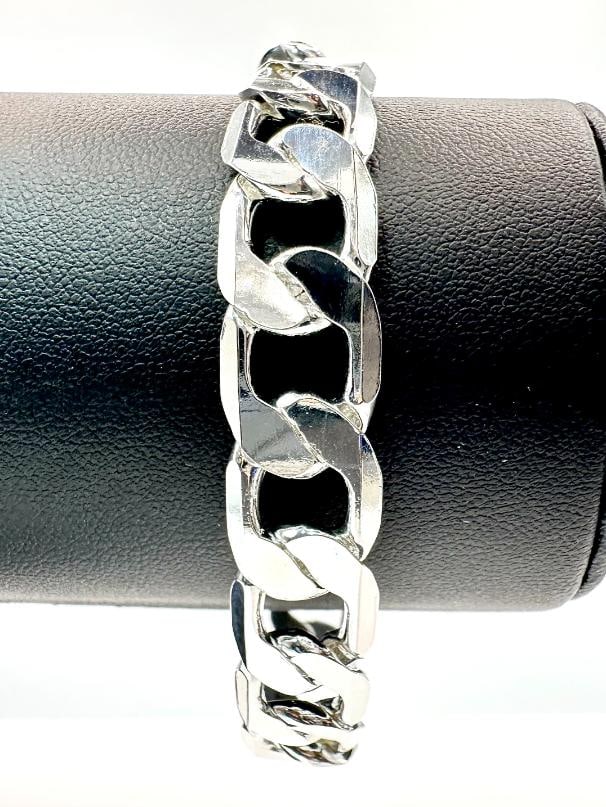 Plated 23.7 Gram Silver Curb Link Bracelet: Strong and durable Plated Sterling Silver curb link bracelet weighing 23.7 grams. 8" in length, 12 mm wide. Sturdy lobster claw style clasp.