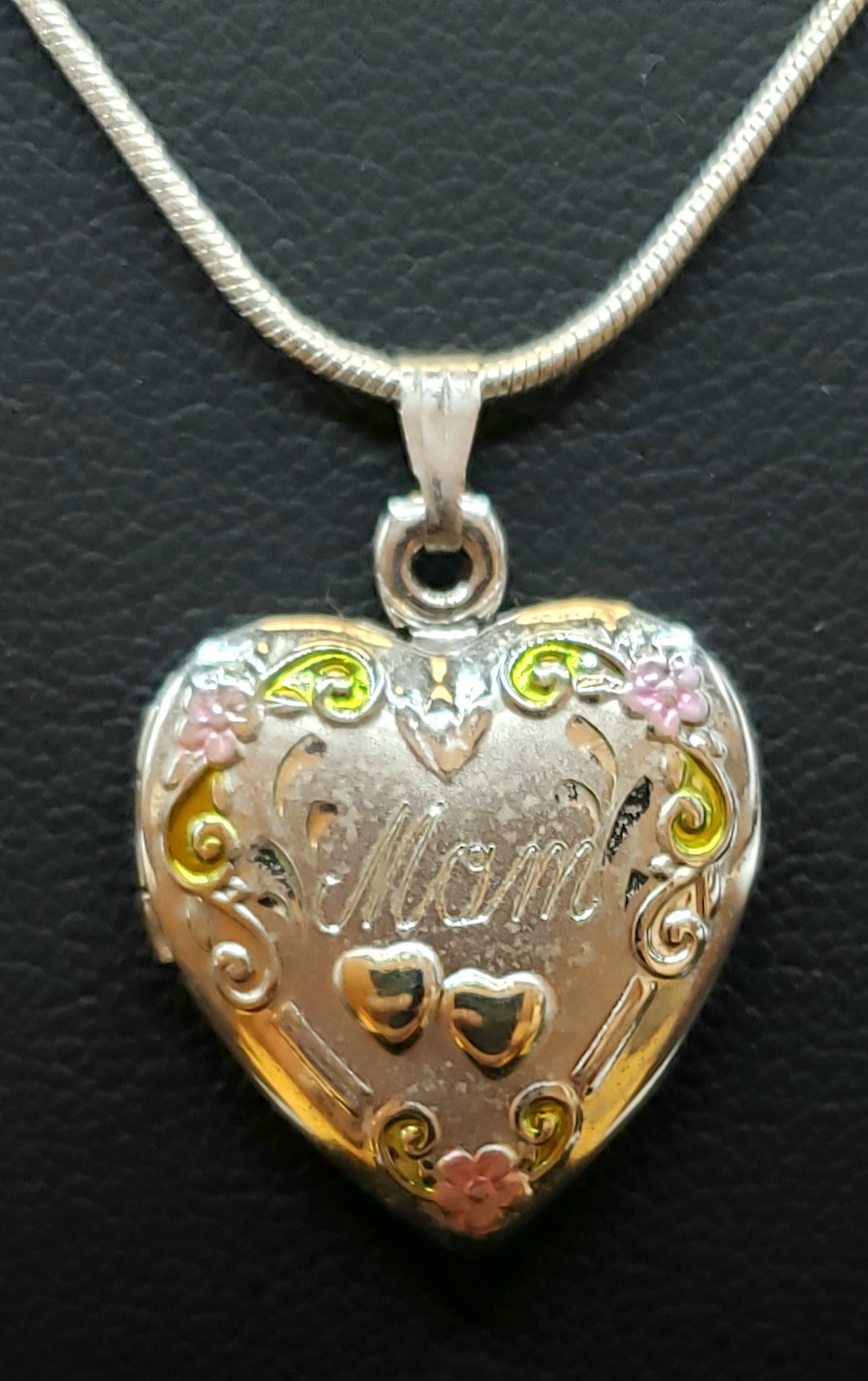 Sterling Silver Mom Heart Locket Necklace: Sterling Silver Mom Heart Locket Necklace. Featuring 14 kt gold plated heart highlights. Includes " necklace.