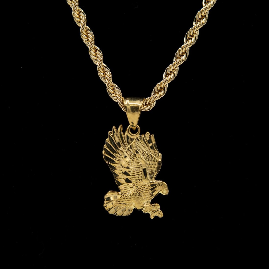 18KT Gold Plated Eagle Pendant And Chain Necklace: Awesome 18 Kt. Gold Plated Eagle Pendant. This Eagle Pendant Has Fine Diamond Cut Etching And Detail. Includes A 24 inch 5 mm. 18 Yellow Gold Plate Rope Chain. With This Very Versatile Pendant/Necklac