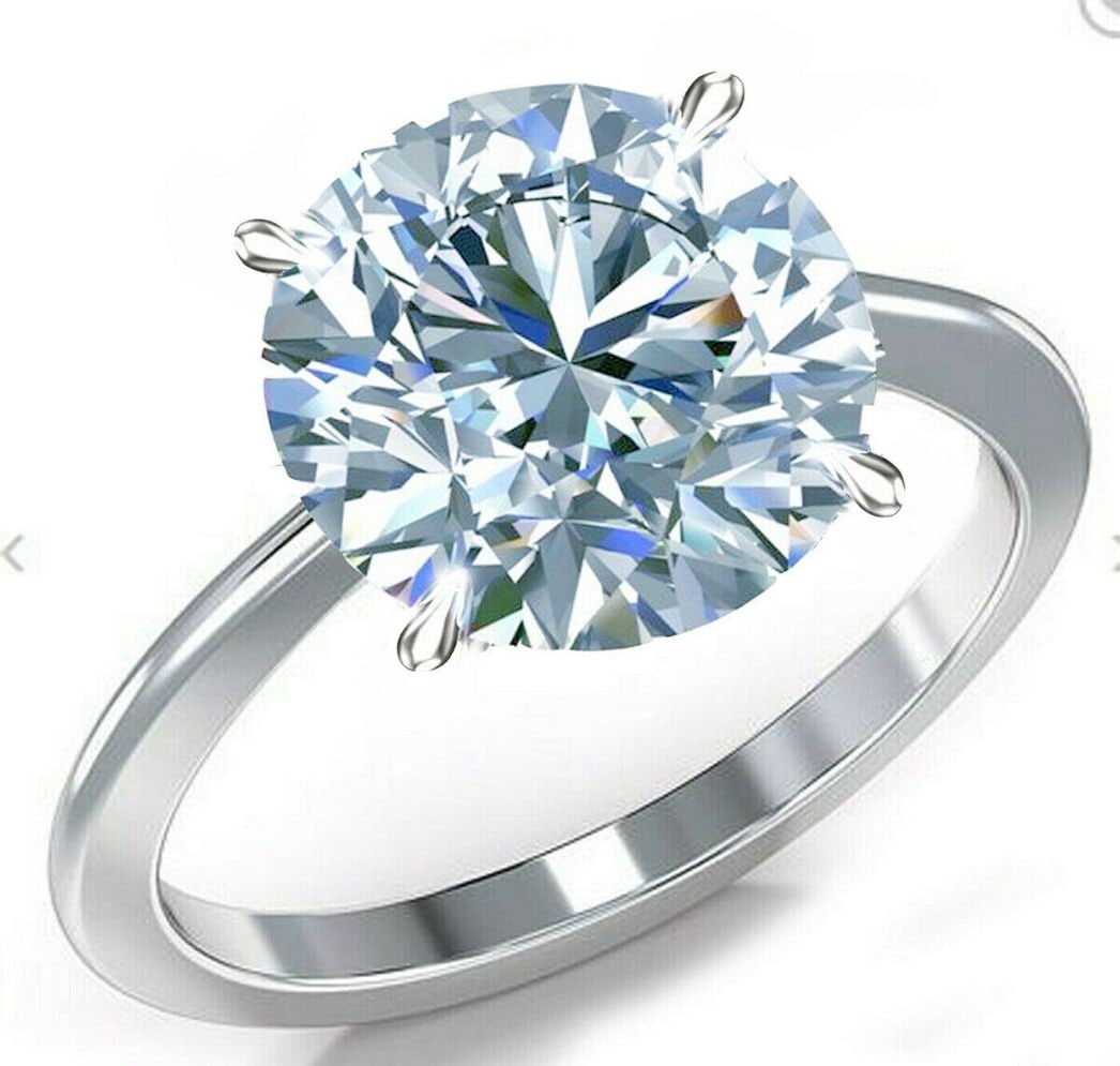 Huge 11.20 Ct VVs1 Ice Blue Fire Moissanite Ring: This Stunning Moissanite Solitaire is a VVS1 Huge 11.20 Ct Brilliant Round Cut Measuring Approx. 14 mm. It is near flawless and bursting out with a full spectrum of colors. This Moissanite is Mounted