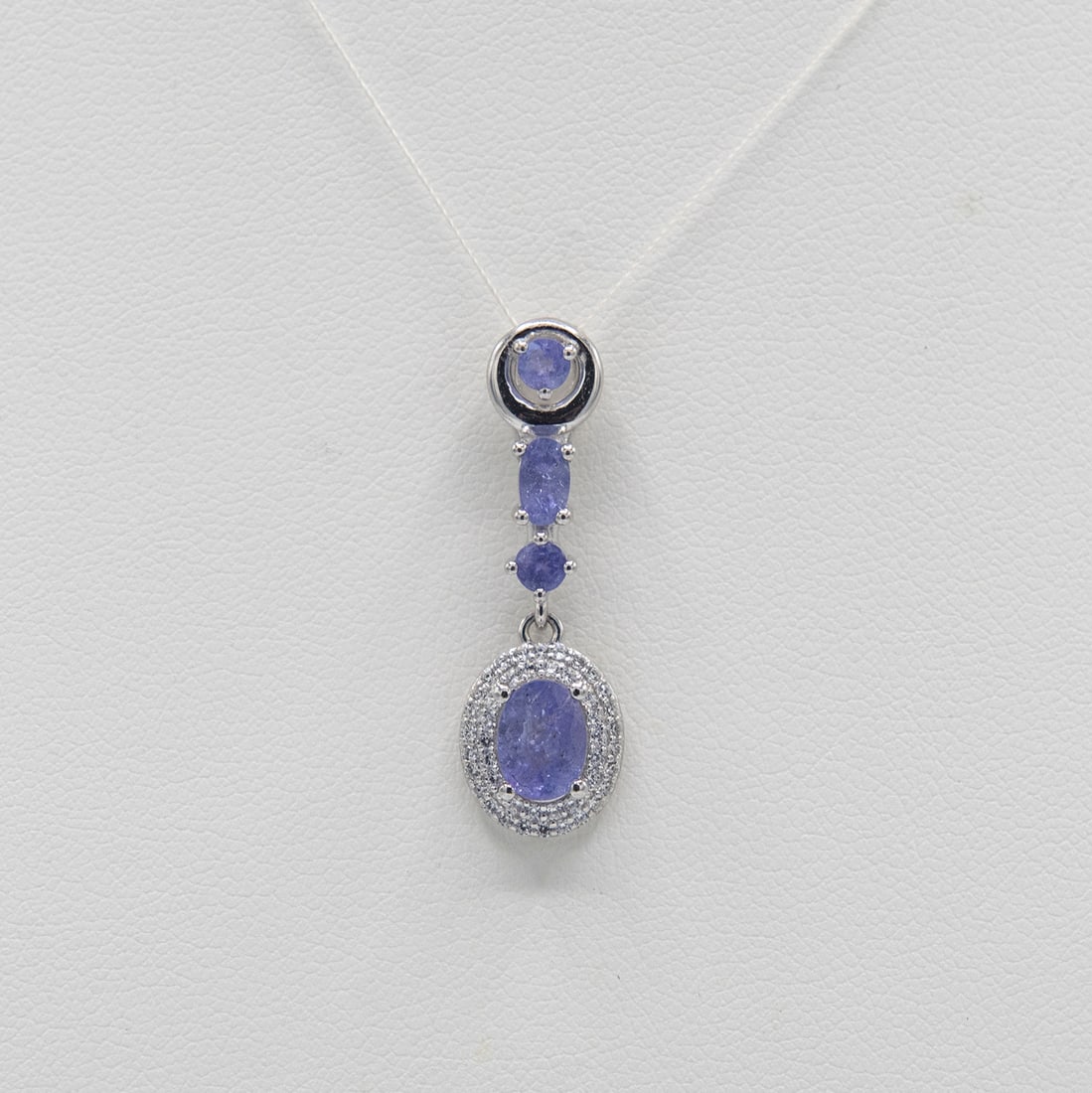 Certified Natural Tanzanite Pendant: Beautiful Certified Natural Tanzanite Pendant. These 4 100 % natural tanzanite's are mounted in elaborately designed solid .925 sterling silver. The tanzanite center stone measures approx. 9 x 7 mm. P