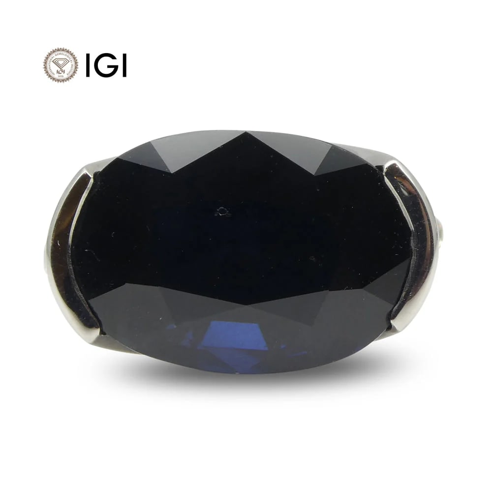 Rare IGI Certified 12.21 Ct Natural Sapphire Ring: Stunning Unheated 12.21 Ct Blue Sapphire and Diamond ring measuring 17.30 x 11.50 x 8.10mm and set in 18k White Gold. Reveals a strong, dark blue tone and is accented with 10 diamond stones. The ring